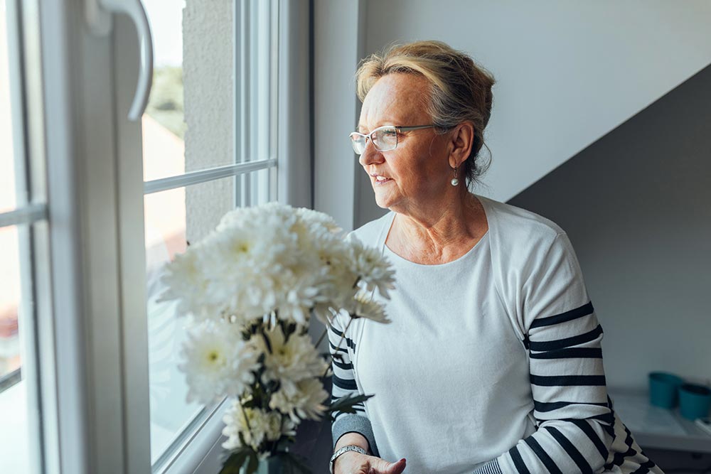anaheimlighthouse-7-challenges-when-starting-recovery-later-in-life-article-photo-shot-of-an-elderly-woman-sitting-by-the-window-763645186