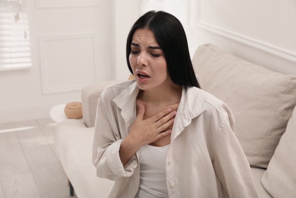 Woman suffering an anxiety attack inside the bedroom