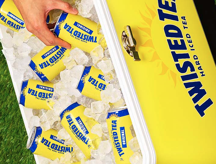 Man getting a can of Twisted Tea from an ice box cooler