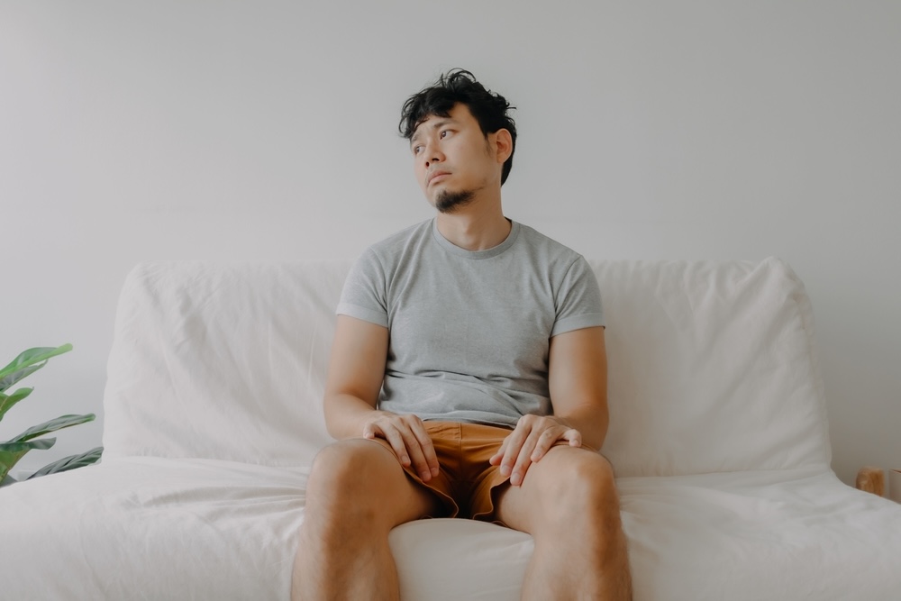 Bored man in addiction recovery sitting on the couch