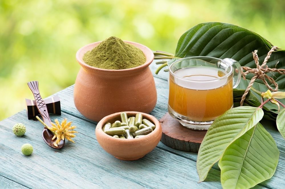 Different types of kratom on a table outdoors