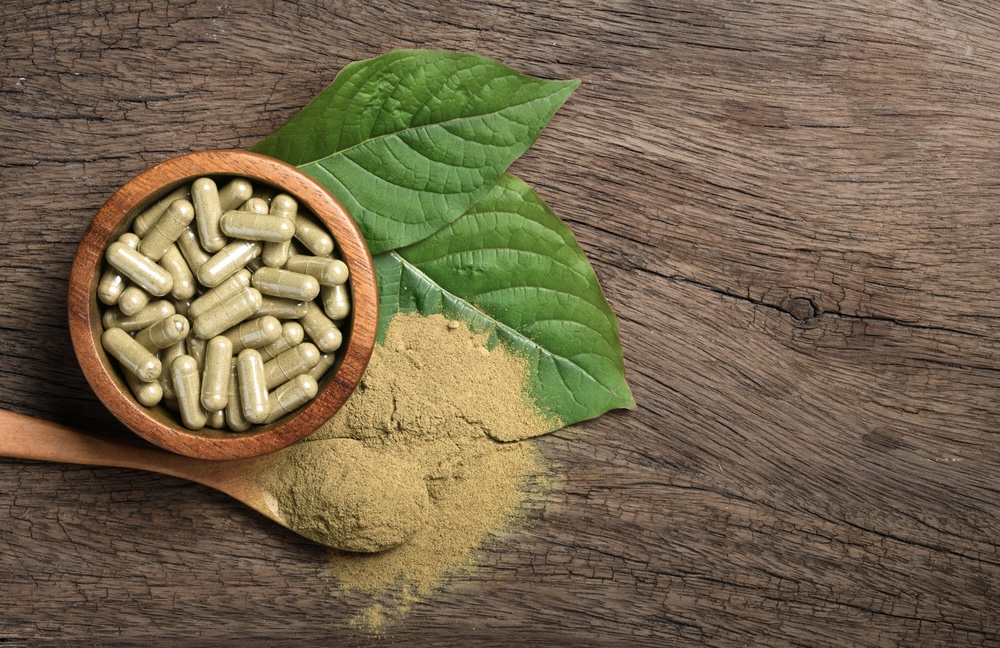Kratom leaves, capsules and powders on a table