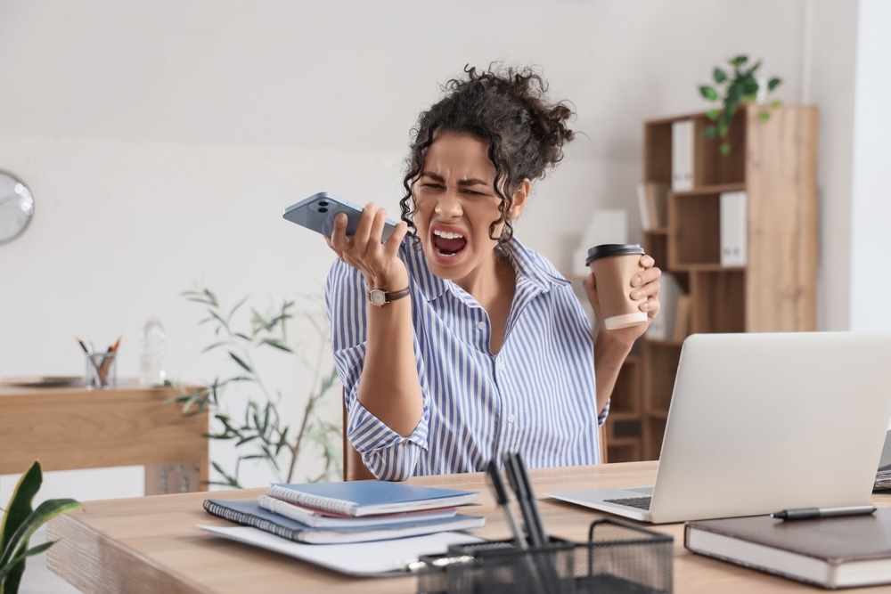 Woman in addiction recovery angry while talking on the phone