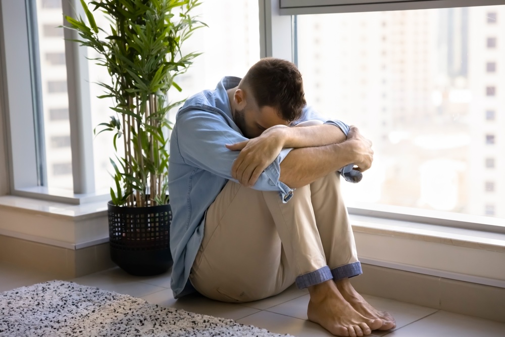 Man sitting on the floor wondering if he can quit Zanax cold turkey